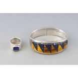 A Mexican white metal double hinged bangle, st with a panel of sodalite and tigers eye,