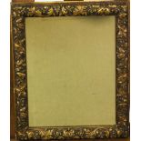 A rectangular gilt framed wall mirror with foliate scroll decoration,