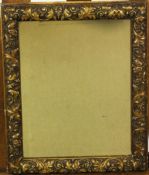 A rectangular gilt framed wall mirror with foliate scroll decoration,