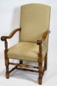 An oak Carolean style scroll end arm chair, raised on turned legs and stretchers,