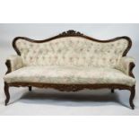 A Victorian mahogany show frame sofa, with arched button back, stuff over seat,