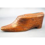A 19th century oak snuff box, in the form of a shoe with brass stud decoration, 10.