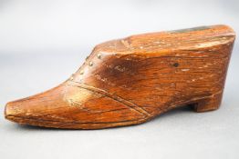 A 19th century oak snuff box, in the form of a shoe with brass stud decoration, 10.