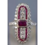 A white metal dress ring centrally set with a rectangular cut ruby measuring approximately 5.