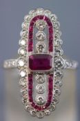 A white metal dress ring centrally set with a rectangular cut ruby measuring approximately 5.