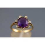 A yellow metal dress ring set with a cushion faceted cut amethyst measuring approximately 9.