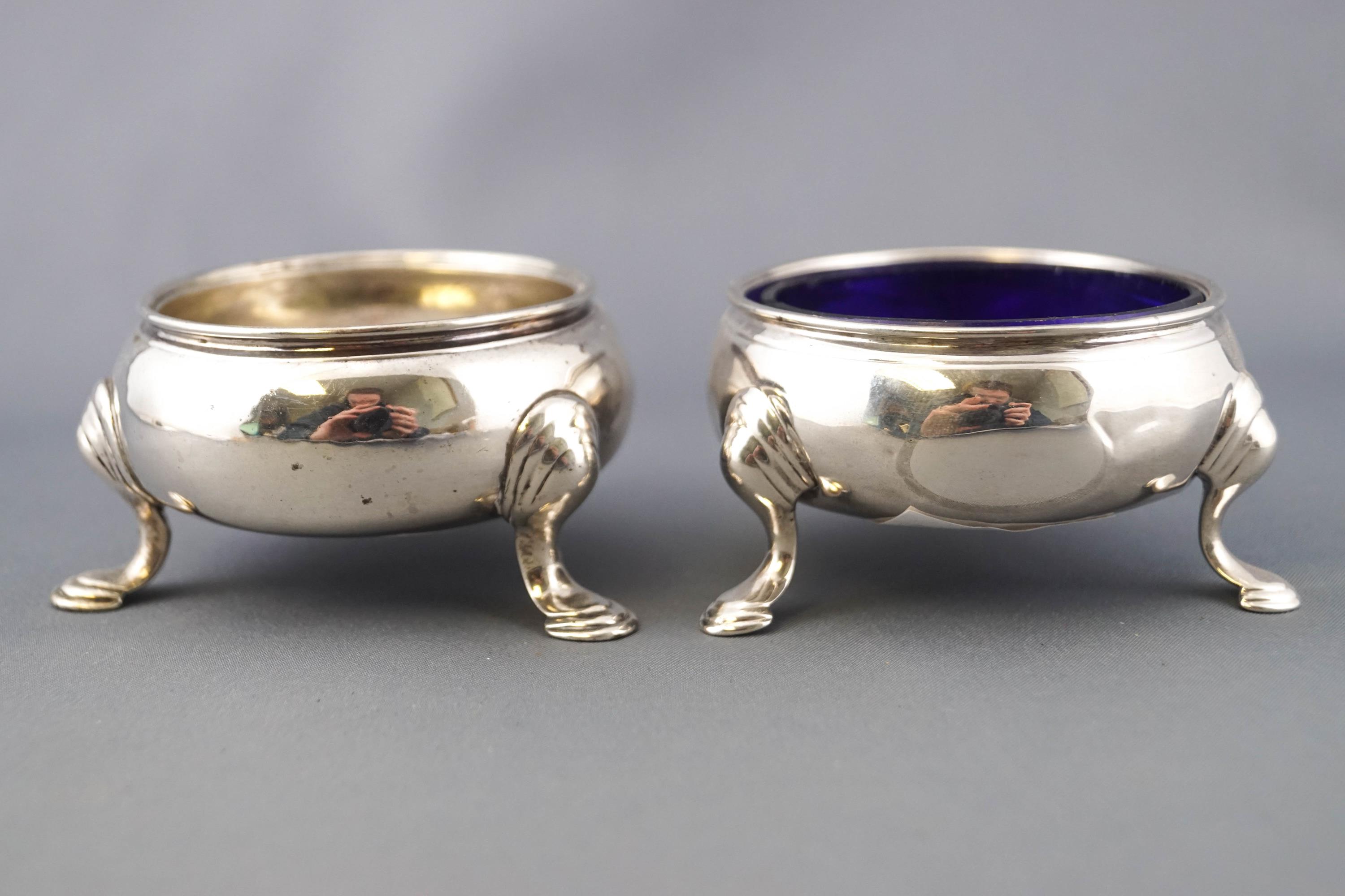 Two Georgian silver cauldron salts, of traditional three leg form, marks rubbed,