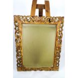 An early 20th century Florentine carved and gilt wood frame with bevelled mirror plate,