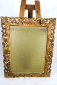 An early 20th century Florentine carved and gilt wood frame with bevelled mirror plate,