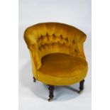 A Victorian tub shaped nursing chair, with button back, on turned mahogany legs with casters,