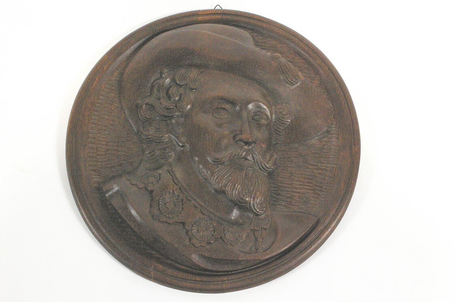 A oak roundel carved with the head of Rubens, 47.