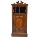 A Victorian mahogany cupboard with raised back and plinth base,