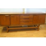 A G-plan teak sideboard, fitted an arrangement of cupboards,