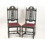 A pair of Victorian oak chairs in the 17th Century style, with barley twist supports,