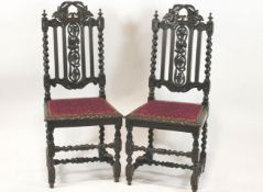 A pair of Victorian oak chairs in the 17th Century style, with barley twist supports,