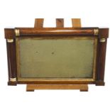 A late Regency mahogany over-mantel mirror, decorated with brass capped half columns,