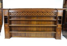 An oak dresser rack, in George III style, with unusual pierced frieze above three open shelves,