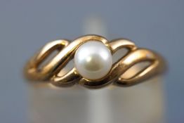 A yellow metal single stone ring set with a 5mm cultured pearl (untested).