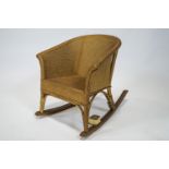 A child's Lloyd Loom stye rocking chair with a musical movement,