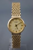 A hallmarked 9ct yellow gold rotary elite wristwatch. Quartz movement. 9ct yellow gold bracelet.