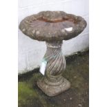 A shell shaped reconstituted stone bird bath,