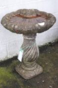 A shell shaped reconstituted stone bird bath,