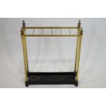 A Victorian brass and cast iron stick stand, of six section form with finials to corners,