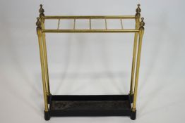 A Victorian brass and cast iron stick stand, of six section form with finials to corners,