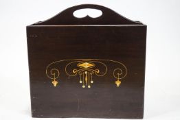 An Art Nouveau two section magazine rack, with central grip handle,