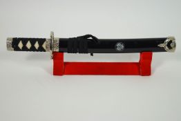 A reproduction mounted samurai sword in scabbard,