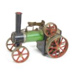 A Mamod traction engine, in green livery with red wheels,