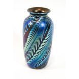 An Okra glass vase, in the Favrille style, with iridescent swirling foliates on a dark ground,