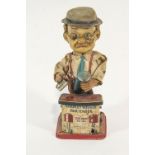 A battery operated tin plate and plastic figure of Charlie Weaver Bartender,
