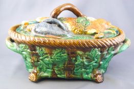 A Minton style Majolica game terrine the lid moulded with a hare and game birds,