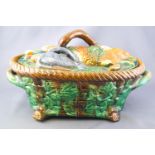 A Minton style Majolica game terrine the lid moulded with a hare and game birds,