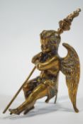 A cast brass of a crouching Putti holding a flambeau,