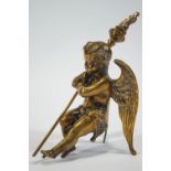 A cast brass of a crouching Putti holding a flambeau,