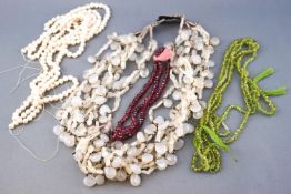 A collection of beads to include a multi strand chalcedony necklace with silver hook clasp;