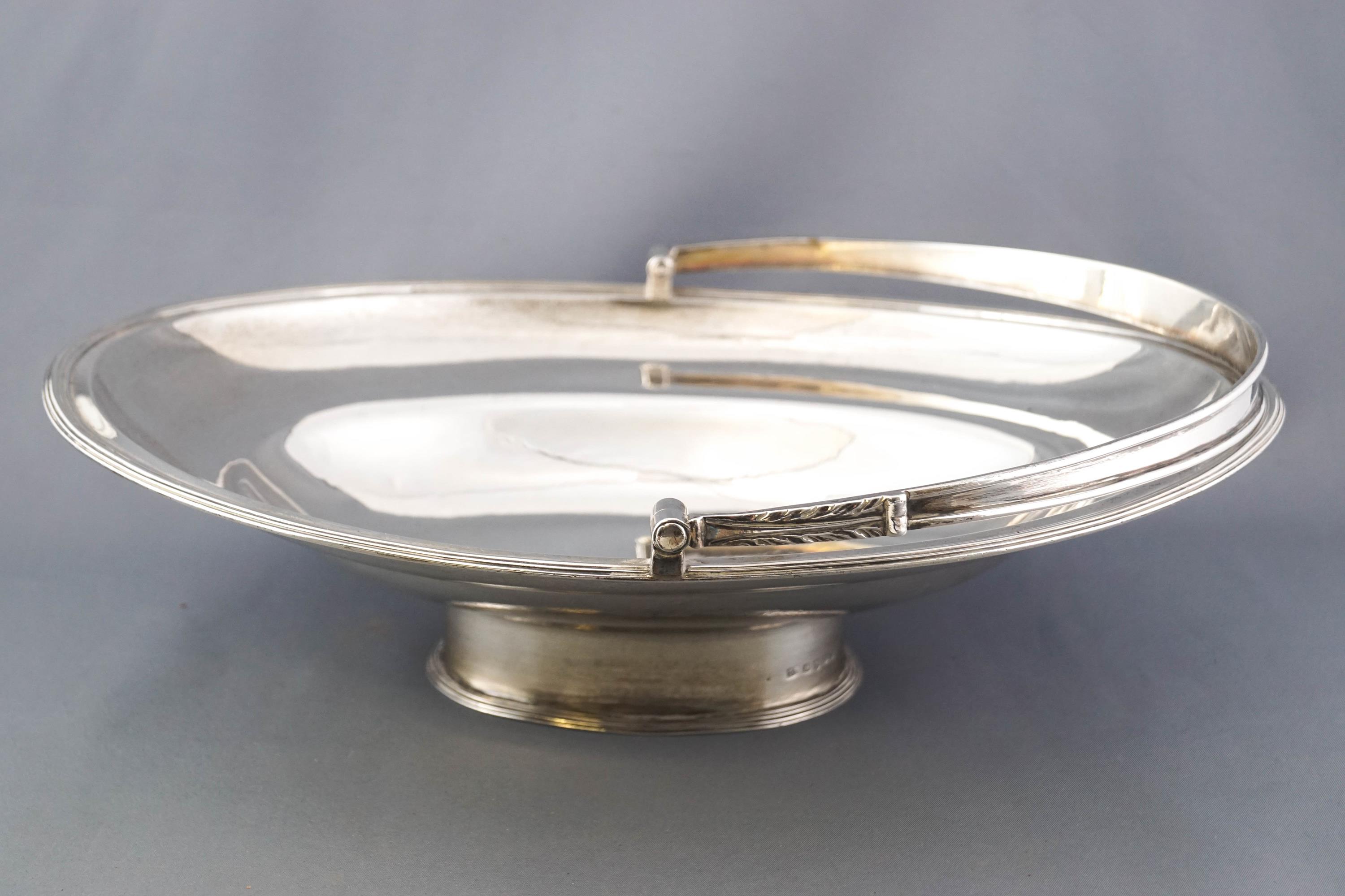 An oval silver swing handled cake basket, of plain form,