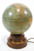 A mid 20th century glass and mahogany globe lamp,