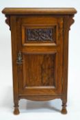 A walnut and oak bedside cabinet,