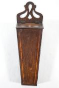 A George III mahogany and boxwood strung candle box with pierced crest,