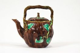 A Minton style Majolica tea pot with foliate decoration and crab stock style handle,