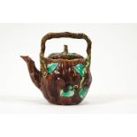 A Minton style Majolica tea pot with foliate decoration and crab stock style handle,