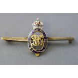 A yellow and white metal royal horse guards bar brooch.