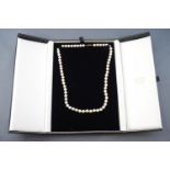 A collection of two items to include: A single strand pearl necklace consisting of sixty five 6.