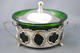 A silver and green glass butter dish, of round form,