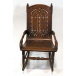 An American rocking chair, with open elbow arms, pierced one piece seat and back,