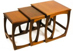 A G-plan nest of three teak tables, each with curved supports,