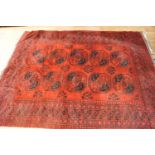 A Turkish caucasian rug with two rows of five medallions on a red ground within multiple borders,